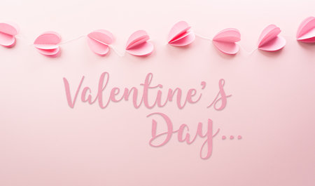 Love and Valentine's day concept made from pink paper hearts and the text on pastel background.の写真素材