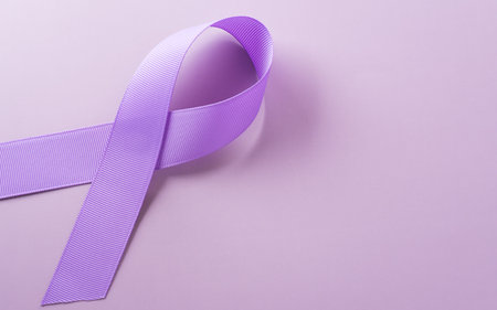 Purple ribbon on pastel paper background for supporting World Cancer Day campaign on February 4.の写真素材