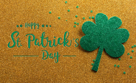 Happy St Patrick's Day decoration concept made from shamrocks ( clover leaf) on golden background.の写真素材