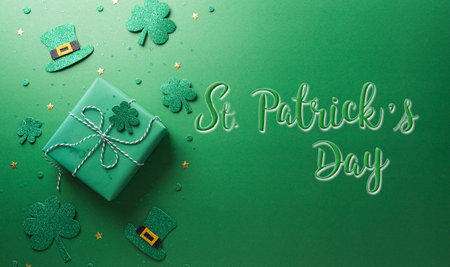 Happy St Patrick's Day decoration concept made from shamrocks ( clover leaf), gift box and leprechaun hat on green background.の写真素材