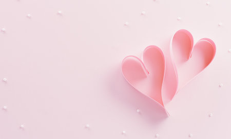 Love and Valentine's day concept made from pink paper hearts on pastel background.の写真素材
