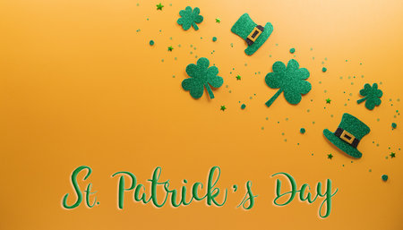 Happy St Patrick's Day decoration concept made from shamrocks ( clover leaf), wooden calendar and leprechaun hat on yellow background.の写真素材