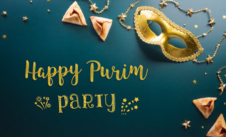 Happy Purim carnival decoration concept made from golden mask star and glitter on dark background. (Happy Purim in Hebrew, jewish holiday celebrate)の写真素材