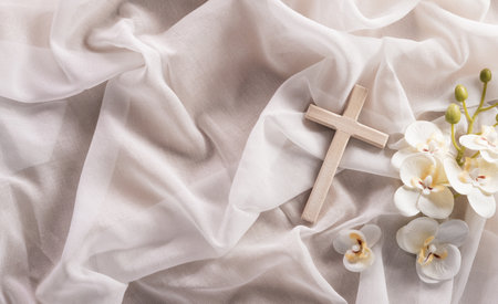 Good Friday and Holy week concept - A religious cross and flower on white fabric background.の写真素材