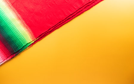 Cinco de Mayo holiday background made from mexican blanket stripes or poncho serape on yellow background.の写真素材