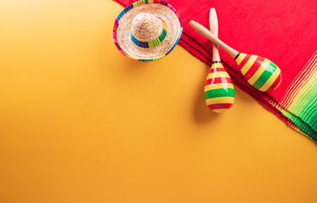 Cinco de Mayo holiday background made from maracas, mexican blanket stripes or poncho serape and hat on yellow background.の写真素材