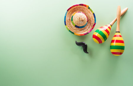 Cinco de Mayo holiday background made from maracas, mexican blanket stripes or poncho serape and hat on pastel background.の写真素材