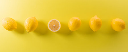 Summer composition made from oranges, lemon or lime on pastel yellow background. Fruit minimal concept. Flat lay, top view, copy space.の写真素材