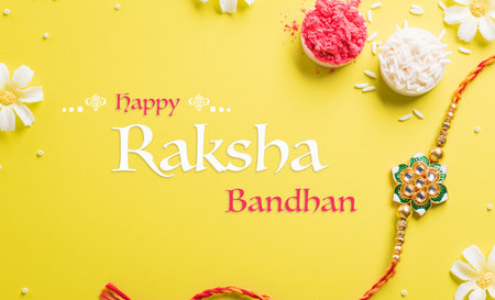 Raksha Bandhan, Indian festival with beautiful Rakhi and Rice Grains on yellow background. A traditional Indian wrist band which is a symbol of love between Sisters and Brothersの写真素材