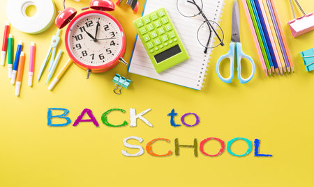 Education or back to school Concept. Top view of Colorful school supplies with books, color pencils, calculator, pen cutter clips and apple on pastel paper background.の写真素材