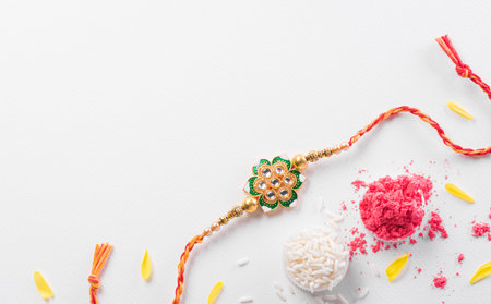 Raksha Bandhan, Indian festival with beautiful Rakhi and Rice Grains. A traditional Indian wrist band which is a symbol of love between Sisters and Brothersの写真素材