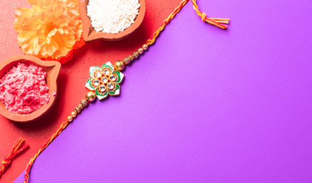 Raksha Bandhan, Indian festival with beautiful Rakhi and Rice Grains.  A traditional Indian wrist band which is a symbol of love between Sisters and Brothers.の写真素材
