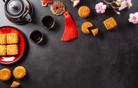 Chinese Mid-Autumn Festival concept made from mooncakes, tea and plum blossom. Chinese characters FU in the article refer to fortune good luck, wealth, money flow.の写真素材