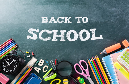 Education or back to school Concept. Top view of Colorful school supplies with books, color pencils, calculator, pen cutter clips chalkboard background.の写真素材