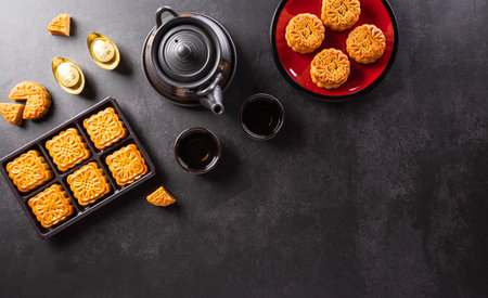 Chinese Mid-Autumn Festival concept made from mooncakes, tea and plum blossom. Chinese characters FU in the article refer to fortune good luck, wealth, money flow.の写真素材