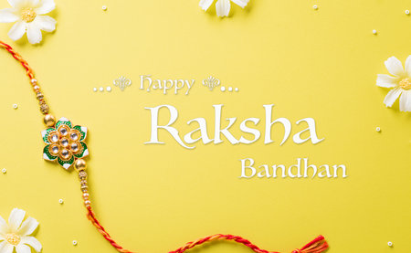 Raksha Bandhan, Indian festival with beautiful Rakhi and Rice Grains on yellow background. A traditional Indian wrist band which is a symbol of love between Sisters and Brothersの写真素材