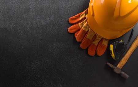 Happy Labor day concept. American flag with different construction tools on dark background.の写真素材