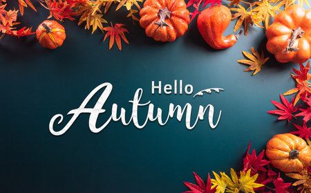 Autumn and thanksgiving decoration concept made from autumn leaves and pumpkin on dark background. Flat lay, top view with copy space.の写真素材