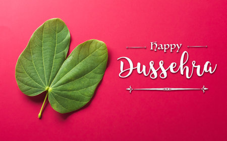Happy Dussehra background concept made from green leaf and the text on red paper background. Dussehra Indian Festival concept.の写真素材