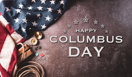 Happy Columbus Day concept. Vintage American flag, compass, paper boat, rope on dark stone background.  Flat lay, top view with copy space.の写真素材