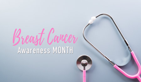 Pink ribbon with the text on pastel paper background for supporting breast cancer awareness month campaign.の写真素材