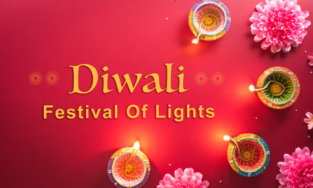 Happy Diwali - Clay Diya lamps lit during Diwali, Hindu festival of lights celebration. Colorful traditional oil lamp diya on red backgroundの写真素材