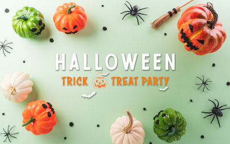 Halloween decorations made from pumpkin, paper bats, black spider on pastel backgroundの写真素材