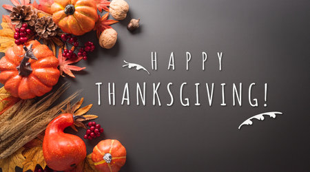 Thanksgiving and Autumn decoration concept made from autumn leaves, pumpkin and the text on dark background.の写真素材