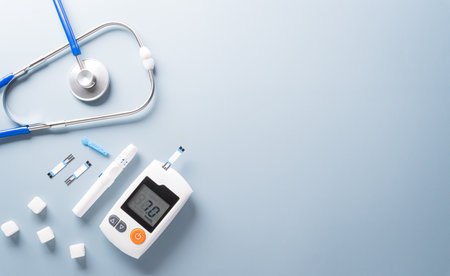 World Diabetes day concept ,14 November. Top view of blood glucose meter sets and stethoscope on pastel blue background.の写真素材