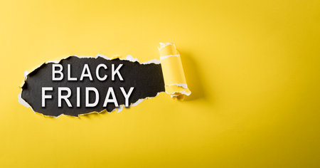 Top view of yellow torn paper and the text on blackboard background. Black Friday composition.の写真素材