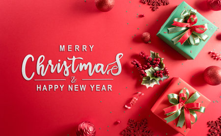 Christmas and new year background concept. Top view of Christmas decoration made from gift box, snowflake, christmas ball and  pine branches on red background.の写真素材