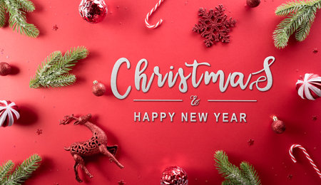 Christmas and new year background concept. Top view of Christmas decoration made from snowflake, christmas ball and  pine branches on red background.の写真素材