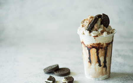 Chocolate milk shakes with cinnamon, chocolate pieces and various spices on stone background.の写真素材