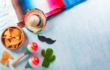 Cinco de Mayo holiday background made from maracas, mexican blanket stripes or poncho serape and hat...