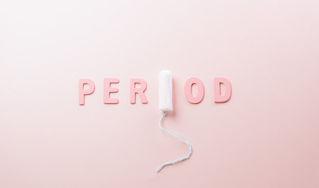 White sanitary pad and the text on pastel background. Woman health or body positive concept.の写真素材