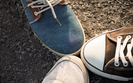 Closeup of shoes in a huddle with their feet together showing unity and teamwork. Friendship,...