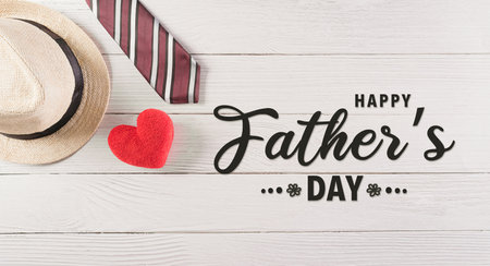 Happy Father's Day decoration with colorful tie with red heart and hat on white wooden background.の写真素材