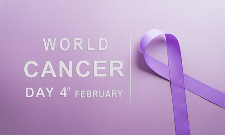 Purple ribbon on pastel paper background for supporting World Cancer Day campaign on February 4.の写真素材