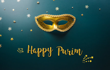 Happy Purim carnival decoration concept made from golden mask star and glitter on dark background. (Happy Purim in Hebrew, jewish holiday celebrate)の写真素材