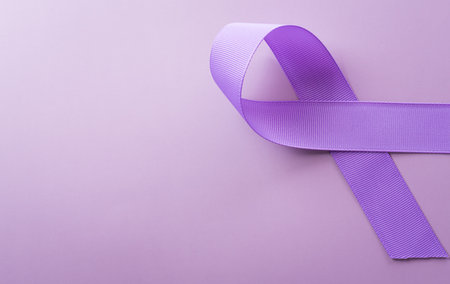 Purple ribbon on pastel paper background for supporting World Cancer Day campaign on February 4.の写真素材