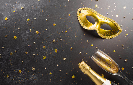 Happy Purim carnival decoration concept made from golden mask star and glitter on dark background. (Happy Purim in Hebrew, jewish holiday celebrate)の写真素材
