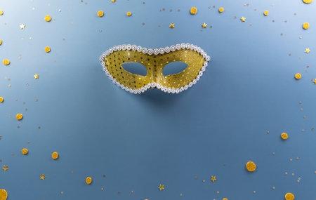 Happy Purim carnival decoration concept made from golden mask star and glitter on pastel background. (Happy Purim in Hebrew, jewish holiday celebrate)の写真素材
