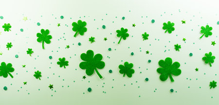 Happy St Patrick's Day decoration concept made from shamrocks ( clover leaf) on green pastel background.の写真素材