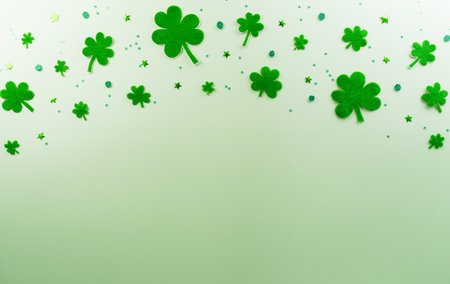 Happy St Patrick's Day decoration concept made from shamrocks ( clover leaf) on green pastel background.の写真素材