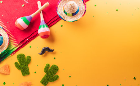 Cinco de Mayo holiday background made from maracas, cactus and hat on yellow background.の写真素材