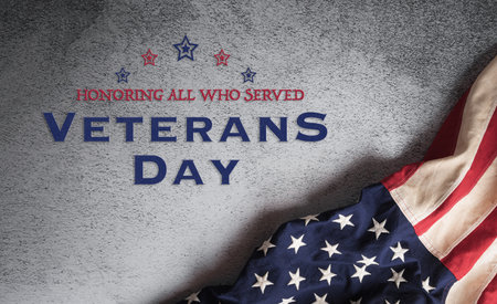 Happy veteran day concept with a flag of the United States and the text on dark  background.の写真素材