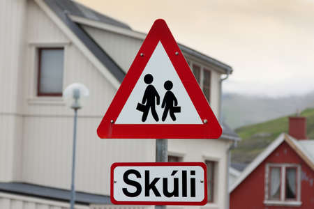 Caution school road sign children crossing in a small village of Faroe Islandsの写真素材