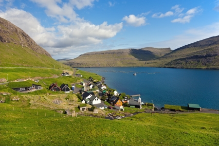 Bour, Faroe Islands.
Typical nordic village overlooking a fjord surrounded by green mountains .
Peaceful landscape in a sunny day .の写真素材