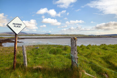 Passing place sign on the side of a rural Scottish road with natural landscape in the backgroundの写真素材