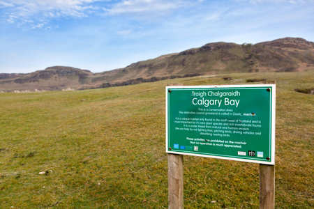 Isle of Mull, Scotland - April 21, 2014   Signpost announcing Calgary Bay, located on the north west of Mull   A broad area of machair  a grassy meadow growing on calcareous sand  lies between the land and the beach の写真素材